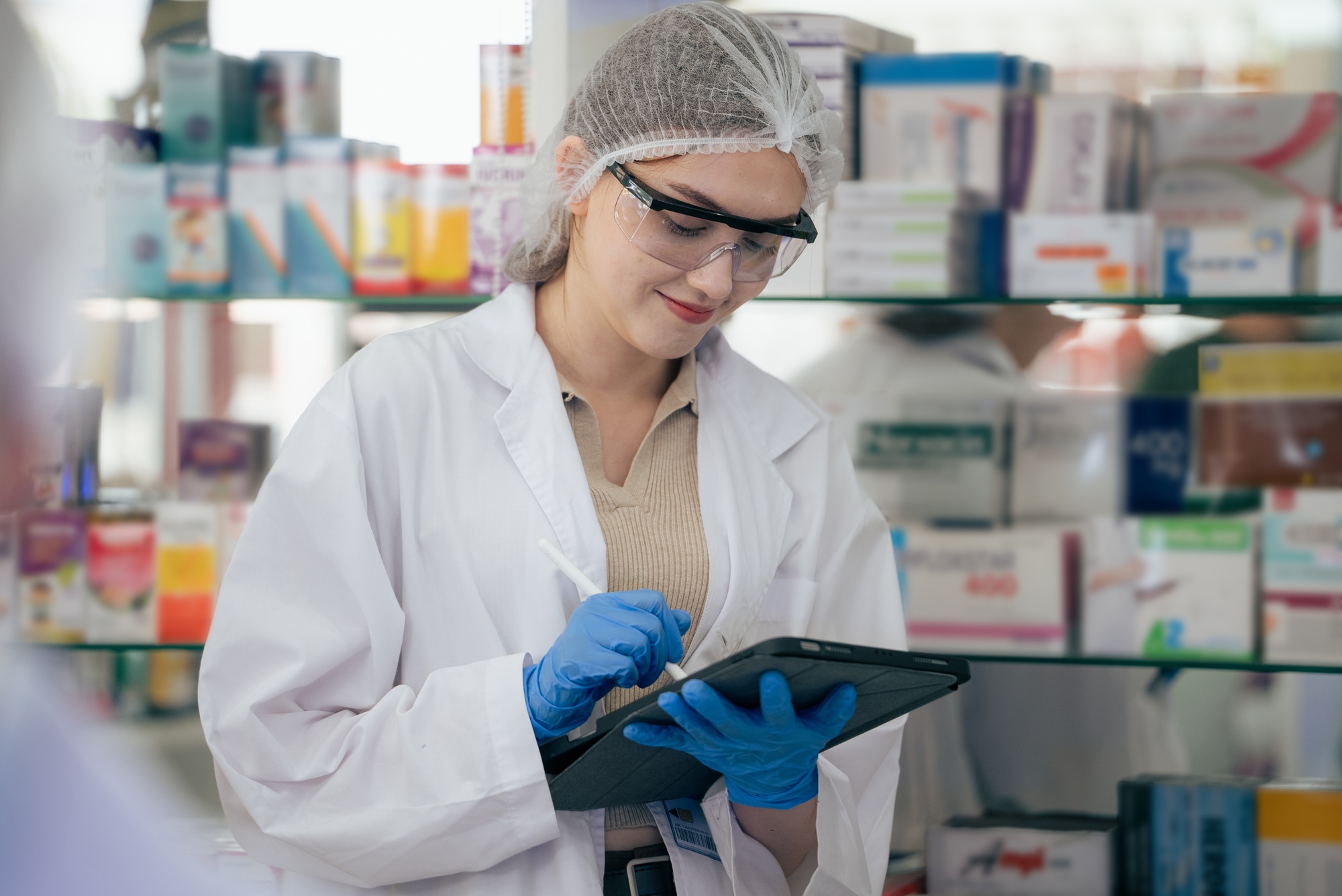 Female scientist using digital tablet for recording data of lab experiment